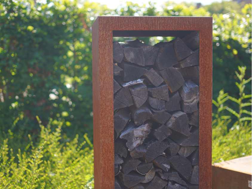 Cortenstahl Holzlager mit Holz gefüllt